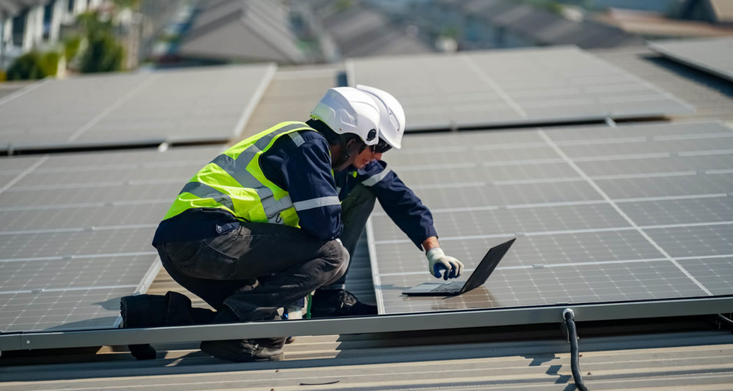 technician doing performance checks on solar panel